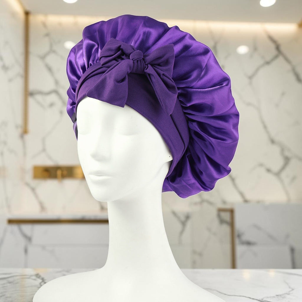 Gorro de satén morado zafiropulse PERENNE Silk Slumber con lazo decorativo sobre maniquí para cuidado del cabello